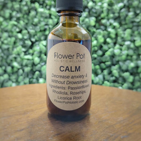 Dropper bottle of holistic wellness tincture with ingredients like passionflower, rhodiola, rosehips, and licorice root for decreasing anxiety and stress naturally.