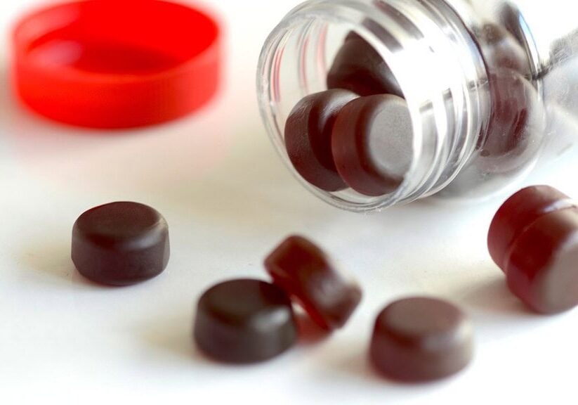 High-quality holistic herbal supplement pills spilled from a transparent container, highlighting natural health remedies and wellness products for optimal health benefits.