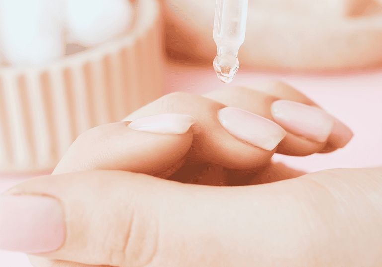 A close-up of a hand receiving a skincare treatment with a dropper, highlighting relaxation, wellness, and natural beauty. Perfect for promoting holistic beauty and spa services at The Flower Pot.
